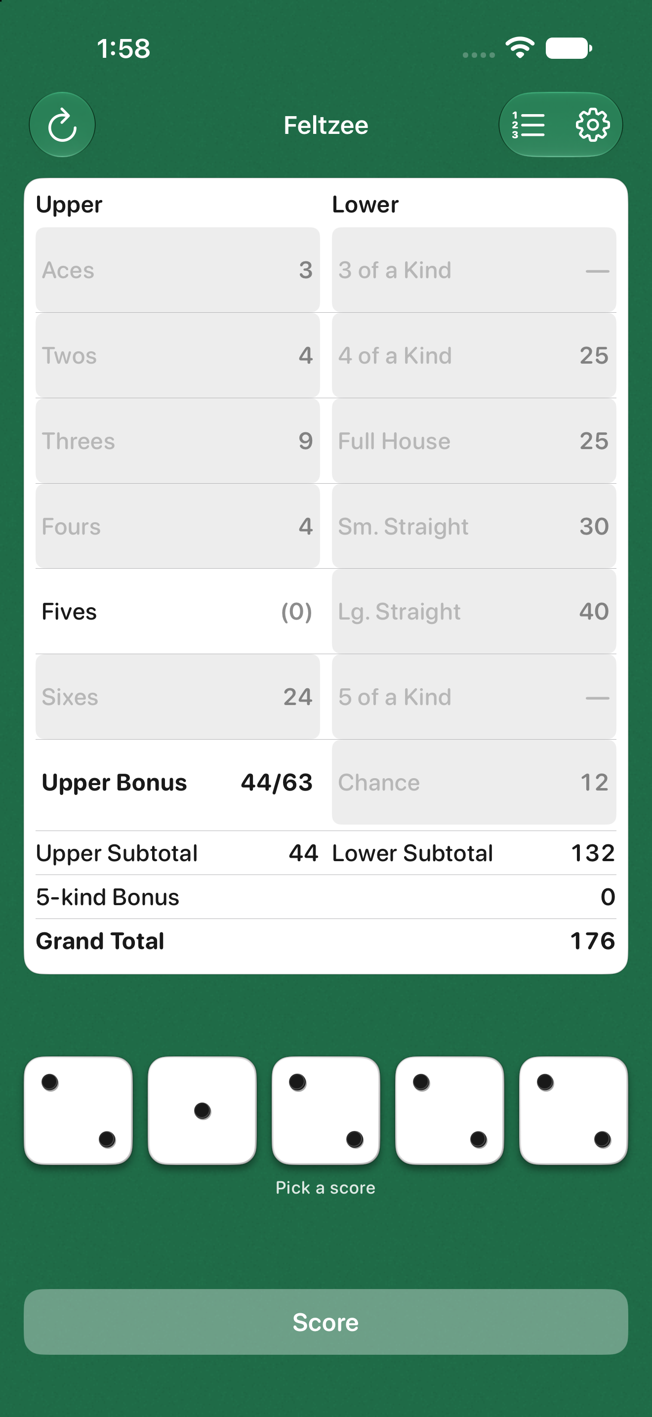 A green felt table with five dice below a two-column scorecard.